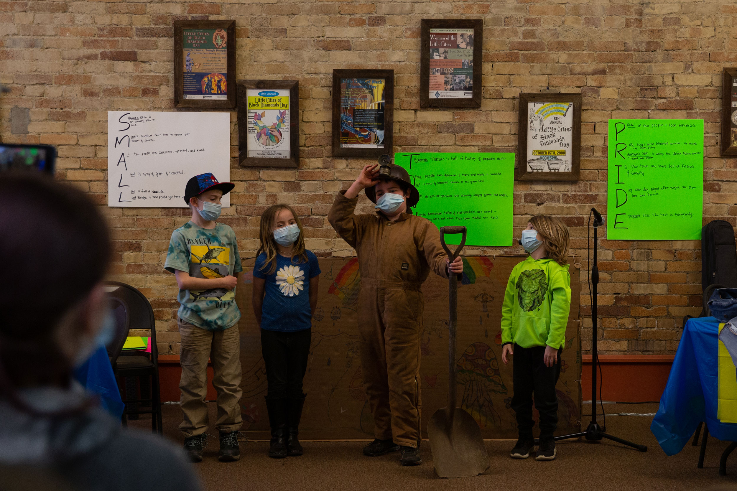Rhys Westenbarger, middle right, tips his helmet up as part of his coal miner costume
during the puppet show wrapping up Saturday Matinees at the Tecumseh Theater on
Saturday, March 26, 2022. (Jesse Jarrold-Grapes)